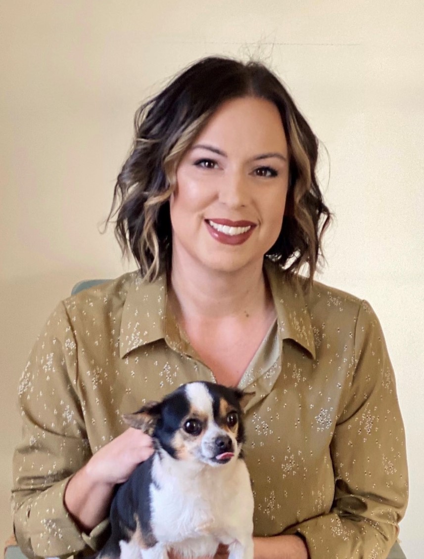 PSI President Beth Stultz-Hairston poses for a headshot while holding a dog.
