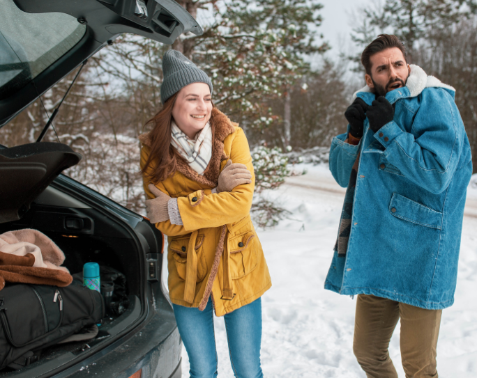Two pet sitters in winter clothing packing truck and preparing to pet sit in snow